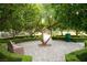Serene park setting with a tree, bench, and landscaped pathway, surrounded by lush greenery at 11036 Parete Ct, Las Vegas, NV 89141