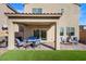 Outdoor living space featuring a covered patio, artificial turf, and a barbecue area at 121 Manzanita Falls Ave, North Las Vegas, NV 89031