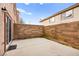 Private backyard featuring a concrete patio surrounded by block wall fencing and access to the residence at 1637 Aspen Meadows Dr, Henderson, NV 89014