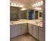 Bright bathroom featuring double sinks, white cabinets, and modern lighting fixtures at 1742 Franklin Chase Ter, Henderson, NV 89012