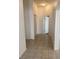 A tiled hallway with neutral walls, closet, recessed lighting, and an arched doorway provides access to other rooms at 1742 Franklin Chase Ter, Henderson, NV 89012