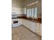 Bright kitchen featuring white cabinets, wood countertops, stainless steel appliances, and tile floors at 1742 Franklin Chase Ter, Henderson, NV 89012