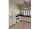Bright kitchen featuring white cabinets, countertops, stainless steel appliances, and tile floors at 1742 Franklin Chase Ter, Henderson, NV 89012