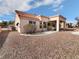 Backyard with desert landscaping, a covered patio, and a stucco exterior with tile roof at 2456 Palmridge Dr, Las Vegas, NV 89134