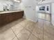 Primary bathroom featuring double sinks with granite countertops, tile flooring, and mirrors at 2456 Palmridge Dr, Las Vegas, NV 89134