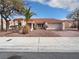 Charming single story home featuring desert landscaping, tile roof, and attached two car garage at 2456 Palmridge Dr, Las Vegas, NV 89134
