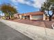 Well-maintained single-story home featuring a tile roof, desert landscaping, and a spacious driveway at 2456 Palmridge Dr, Las Vegas, NV 89134