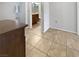 Hallway featuring tile flooring, access to a bathroom with granite countertops, and neutral wall paint at 2456 Palmridge Dr, Las Vegas, NV 89134