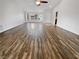 Spacious living room showcasing hardwood floors, a large window, and neutral walls at 2456 Palmridge Dr, Las Vegas, NV 89134