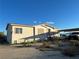 View of the house featuring a quaint exterior, access stairs, desert landscape, and a covered parking area at 2471 Mcmurray Dr, Pahrump, NV 89060