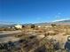 Distant view of several houses showcasing a serene desert landscape and distant mountain views at 2471 Mcmurray Dr, Pahrump, NV 89060