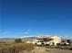 The house exhibits an unassuming facade, complemented by a wide landscape with a desert view at 2471 Mcmurray Dr, Pahrump, NV 89060