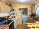 The kitchen provides an eye to the laundry area, and features yellow cabinets and colorful countertops at 2471 Mcmurray Dr, Pahrump, NV 89060