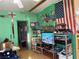 A living area with distinctive green walls and an eccentric arrangement of decor at 2471 Mcmurray Dr, Pahrump, NV 89060