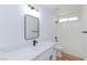 Bathroom featuring a shower-tub combo, large mirror, and a white vanity at 2519 Sidney Spring St, North Las Vegas, NV 89030