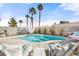 Sparkling backyard pool area with lounge chairs and tall palms creating a relaxing oasis at 266 Corvallis Ct, Henderson, NV 89074