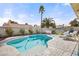 Relaxing backyard with a sparkling pool, lounge chairs, and lush landscaping at 266 Corvallis Ct, Henderson, NV 89074