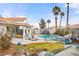 Spacious backyard with a pool, spa, water feature, and lush landscaping at 266 Corvallis Ct, Henderson, NV 89074