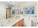 Well-lit bathroom featuring double sinks, framed art, and a shower/tub combination at 266 Corvallis Ct, Henderson, NV 89074
