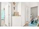 Bright hallway leading to a laundry room with a full-size washer and dryer at 266 Corvallis Ct, Henderson, NV 89074