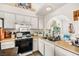 Functional kitchen with white cabinets, laminate countertops, and modern appliances at 266 Corvallis Ct, Henderson, NV 89074