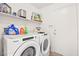 Functional laundry room features modern Whirlpool washer and dryer with convenient shelf storage at 266 Corvallis Ct, Henderson, NV 89074