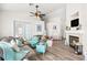 Inviting living room featuring a cozy fireplace, wood floors, ceiling fan and comfortable seating at 266 Corvallis Ct, Henderson, NV 89074