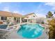 Sparkling backyard pool surrounded by lounge chairs and lush landscaping, perfect for relaxation at 266 Corvallis Ct, Henderson, NV 89074