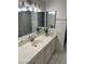 A well-lit bathroom featuring a vanity with double mirrors, perfect for personal grooming at 2692 Matogroso Ln, Las Vegas, NV 89121