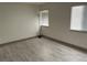 A simple bedroom features a sleek floor lamp and natural light filtering in from the window at 2692 Matogroso Ln, Las Vegas, NV 89121