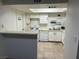 A well-lit kitchen featuring white cabinetry, an open layout, and matching white appliances at 2692 Matogroso Ln, Las Vegas, NV 89121