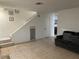 Open living space with tiled floors, neutral walls, access to stairs and under-stairs storage at 2692 Matogroso Ln, Las Vegas, NV 89121