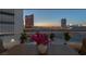 This beautiful balcony view is enhanced with a table, chairs, and potted plants overlooking the Las Vegas skyline at dusk at 2747 Paradise Rd # 404, Las Vegas, NV 89109