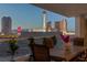 Outdoor balcony with wooden dining table and views of the vibrant Las Vegas Strip at twilight at 2747 Paradise Rd # 404, Las Vegas, NV 89109