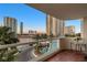 Relax on this spacious balcony with city views and a decorative pool area below at 2747 Paradise Rd # 404, Las Vegas, NV 89109