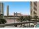 High-rise balcony with a view of Las Vegas city buildings and lush palm trees at 2747 Paradise Rd # 404, Las Vegas, NV 89109