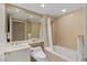 Bright bathroom featuring a shower-tub combo, large mirror, and elegant fixtures at 2747 Paradise Rd # 404, Las Vegas, NV 89109