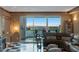 Inviting living room featuring a leather sofa, balcony access, and checkered floors at 2747 Paradise Rd # 404, Las Vegas, NV 89109