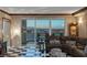 Comfortable living room featuring a checkered floor, leather sofa, and a view of the city skyline at 2747 Paradise Rd # 404, Las Vegas, NV 89109
