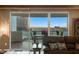 Comfortable living room featuring a leather sofa, balcony access, and checkered floors at 2747 Paradise Rd # 404, Las Vegas, NV 89109