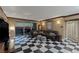 A spacious living room with black and white tile flooring, a large sofa, and a sunset view at 2747 Paradise Rd # 404, Las Vegas, NV 89109
