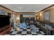 Bright living room with checkered floors, comfortable seating, and city views through sliding glass doors at 2747 Paradise Rd # 404, Las Vegas, NV 89109