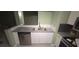 Shows the kitchen with a double basin stainless steel sink and newer appliances at 2981 Country Manor Ln # 2, Las Vegas, NV 89115