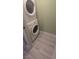 The laundry area has a stacked washer and dryer unit with new flooring at 2981 Country Manor Ln # 2, Las Vegas, NV 89115