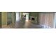 View of the living room with painted fireplace, wood-look floors, and sliding doors at 2981 Country Manor Ln # 2, Las Vegas, NV 89115
