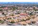 A lovely community with palm trees and terracotta roofs with a view of the city skyline at 3117 Firenze Ct, Las Vegas, NV 89128