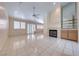 Open living room area showcasing tile flooring, fireplace, and access to the outdoor area at 3117 Firenze Ct, Las Vegas, NV 89128