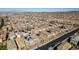 An aerial view shows desert homes with tile roofs in a planned community set against a mountain skyline at 3192 Bormida Ave, Henderson, NV 89044