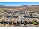 An aerial view shows desert homes in a neighborhood with desert landscape and mountain views at 3192 Bormida Ave, Henderson, NV 89044