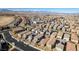An aerial view shows desert homes with tile roofs in a large planned community set against a mountain skyline at 3192 Bormida Ave, Henderson, NV 89044